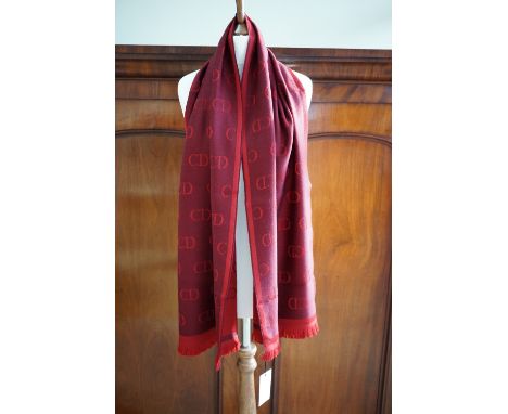 A contemporary Christian Dior wool scarf, in burgundy and plum, having a self patterned design with repeating 'CD' logo, 160 
