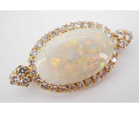 An impressive high-carat yellow-metal, diamond and opal pendant brooch, the central oval cabochon of approximately 26 x 17 mm