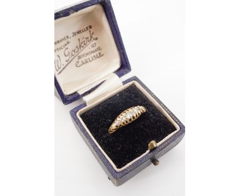 An antique 18ct gold five stone diamond ring, the central diamond of approximately .10ct, held in an open claw setting, with 