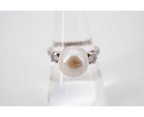 A vintage high carat white metal, diamond and natural saltwater baroque pearl ring, the central pearl of approximately 9mm di