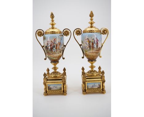 A pair of late 19th Century gilt metal mounted ceramic garniture urns, each oviform, with domed faux cover, scroll handles an