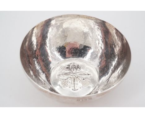A Keswick School of Industrial Arts signed silver bowl, of hemispherical form with flattened base and repousse moulded decora