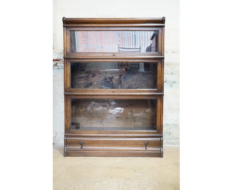 A Globe Wernicke four-section oak bookcase, the lower stage being a base with drawer