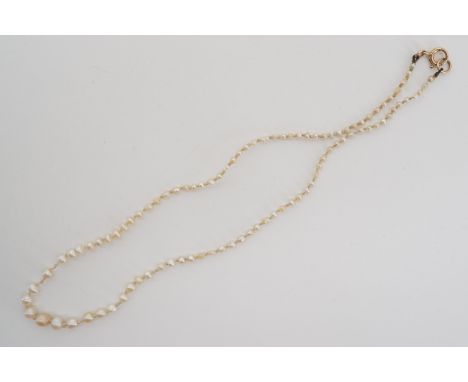 A vintage single strand necklace of graded pearls, on a yellow-metal clasp, stamped '9ct', tests as gold, largest pearl 5mm