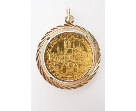 A 1972 Munich Summer Olympics fine gold football token in yellow metal pendant mount, 26 mm (in mount), 5.2 g total weight