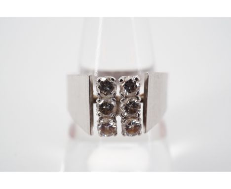 A 20th Century diamond and high carat white metal cocktail ring, having six brilliant cut diamonds, each of approximately .10