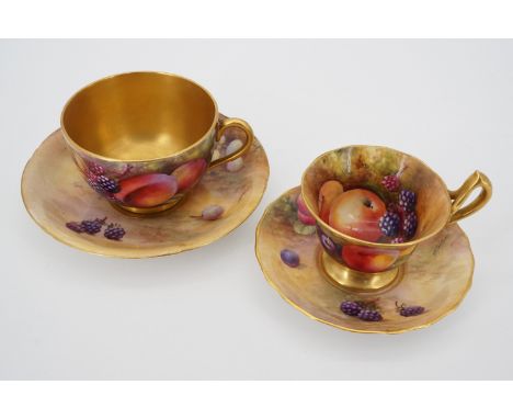 Two Royal Worcester fruit study cups with associated saucers, hand-painted respectively by Horace Price and George Moseley 