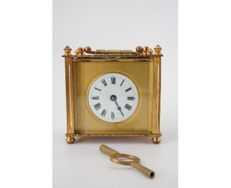 A late 19th Century French carriage clock of squat proportions, in transit case, 9 cm high excluding handle