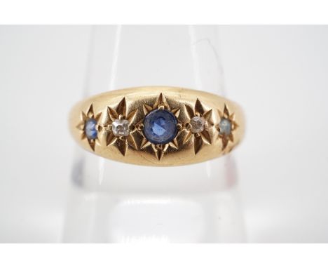 An early 20th Century sapphire and diamond ring, the brilliants gypsy set on an 18ct gold shank, 2.6 g, (shank cut)