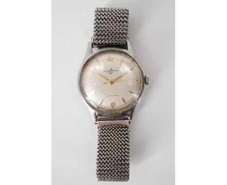A Ulysse Nardin wrist watch, having an automatic movement and brushed silver face with gilt baton markers and Arabic numerals