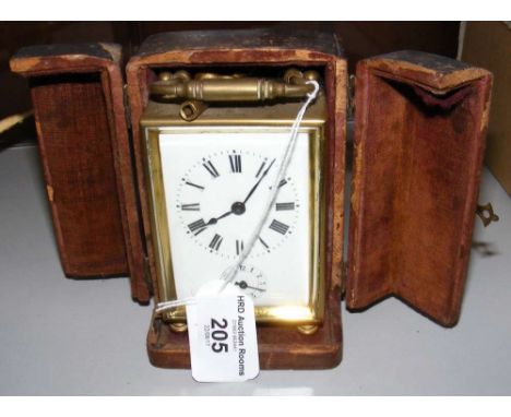 A French brass cased carriage clock with leather carrying case