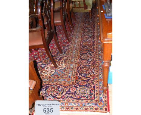 A large Middle Eastern style carpet, having geometric border and centre medallions - 420cm x 296cm