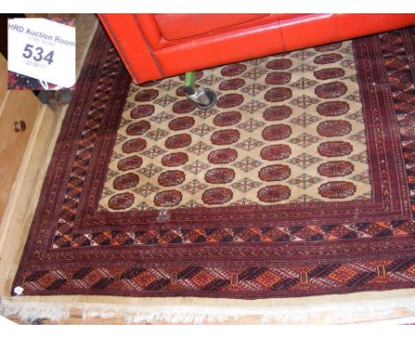 A Middle Eastern style carpet with geometric border and centre medallion - 270cm x 185cm