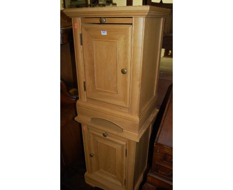 A pair of contemporary light oak single door bedside cupboards 