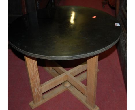 A 1930s circular laminate topped and light oak based low occasional table 