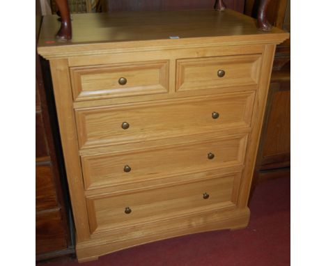 A contemporary light oak squarefront chest of two short over three long graduated drawers 