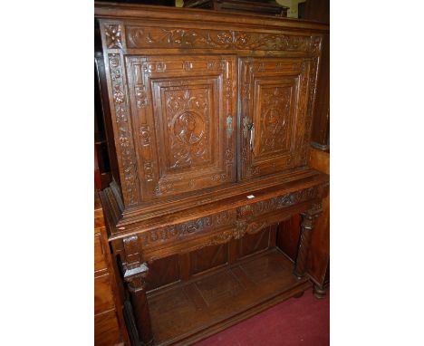 A Continental carved and joined oak two door buffet side cupboard on stand 