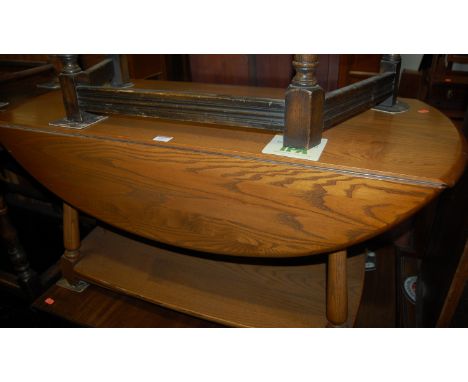 An Ercol mid-elm dropflap two tier coffee table 