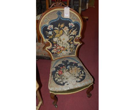 A Victorian mahogany and floral tapestry upholstered nursing chair 