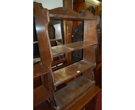 An early 20th century oak four tier open hanging wall shelf; together with a mahogany three tier example (2) 