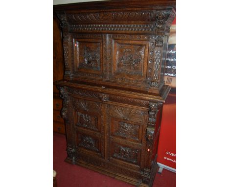 A good late 19th century Flemish heavily carved oak buffet cabinet, the twin door upper section having relief carved doors ov