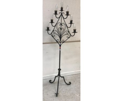 A modern wrought iron seven light lamp standard on scroll work tripod base, 57 cm wide x approx 157 cm high, together with an