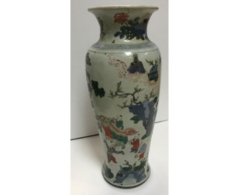 A Chinese Kangxi Period (1662-1722) famille verte vase with flared rim over a shallow baluster body decorated with figures in