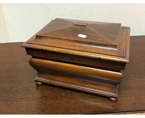 A Victorian walnut jewellery casket of sarcophagus bombé form, the top opening to reveal a fitted interior with lift-out tray