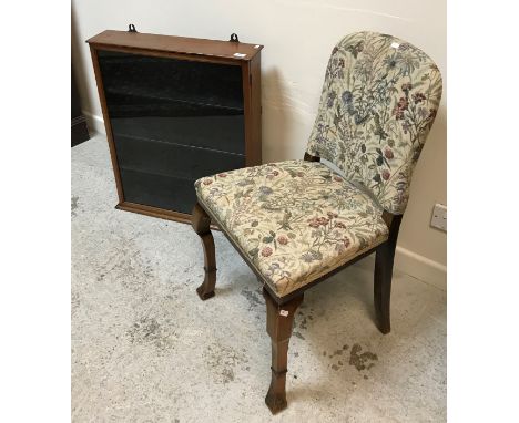 An early 20th Century upholstered walnut-framed hall chair, the low back with fingerhold verso, raised on square collared cab