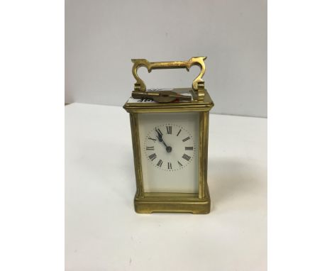 A circa 1900 lacquered brass cased carriage clock, approx 14.5 cm high total