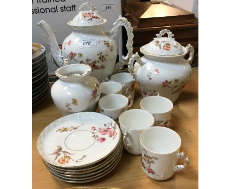 A circa 1900 French floral spray decorated coffee set comprising coffee pot, cream jug and sugar basin together with six cans