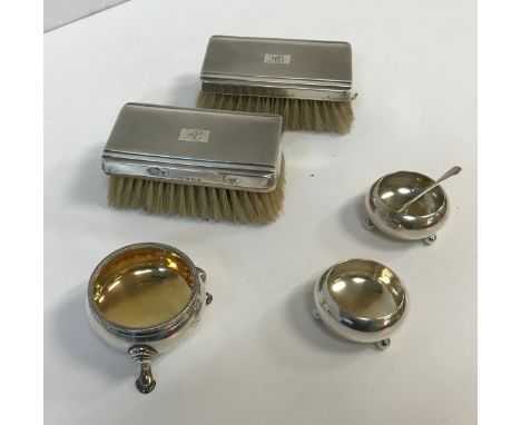 A pair of Victorian silver open salts of plain circular form, raised on three ball feet (by Atkin Brothers, Sheffield 1886), 