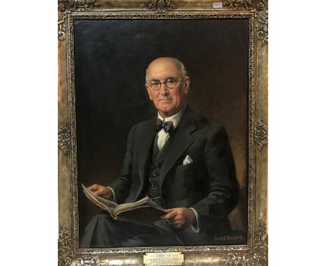 FRANK ERNEST BERESFORD (1881-1967) "B.H. Binder, Esq., F.C.A.", a portrait study half-length seated reading a book, oil on ca