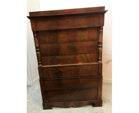 A 19th Century walnut veneered chest on chest in the Biedermeier manner, the caddy type top over a single long drawer and thr