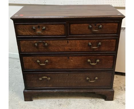 A George III North Country English oak and cross-banded chest, the top with applied moulded edge over two short and three lon