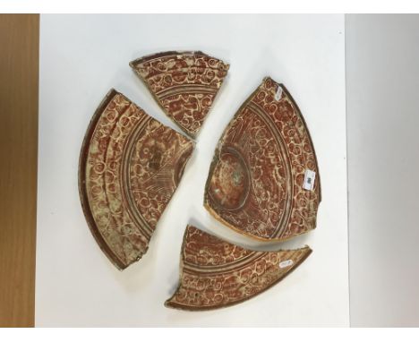 An early Hispano Moresque charger decorated in ruby lustre with scrolling foliage and scroll work decoration verso, 39 cm dia
