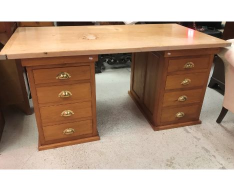 A modern stained beech and pine double pedestal desk, the plain top on two banks of four drawers with brass cup handles, 166.