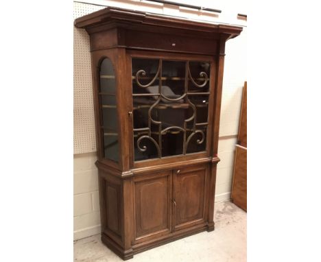 A 19th Century Dutch oak display cabinet, the moulded cornice over a single glazed door enclosing a painted interior with thr