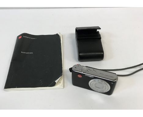 A Leica C-Lux I camera with leather case and instruction manual