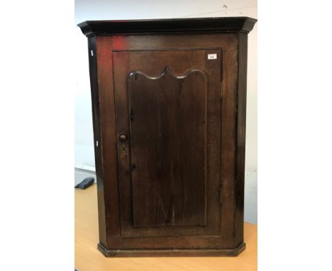 A 19th Century oak hanging corner cupboard, the molded cornice over a single panel door enclosing two plain shelves, 81cm wid