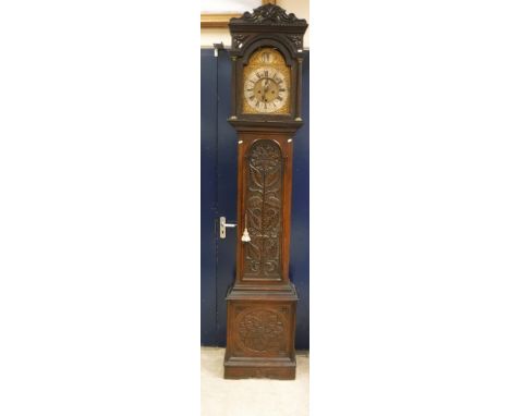 An 18th Century oak cased long case clock, the eight day movement by Christopher Pinchbeck of London with brass arch dial and