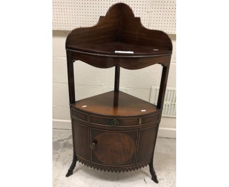 A 19th Century mahogany corner washstand with galleried back over three bowl recesses and cover, over a shelf and single draw