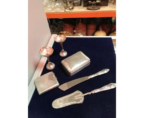 A collection of silver items to include a silver cigarette box, a pair of loaded silver spill vases, a silver cigarette box w