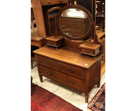 An Edwardian mahogany dressing chest with mirrored super structure over two short and one long drawer on square tapered legs 