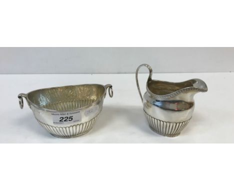 A Victorian silver cream jug of oval semi-fluted form with harebell relief work banding (by Thomas William Dobson and Henry H