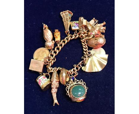 A 9 carat gold chain link charm bracelet, together with a collection of seventeen various gold charms and a 1911 half soverei