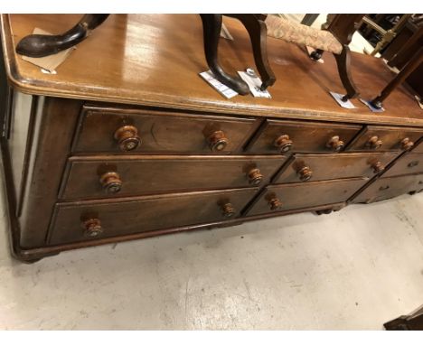 A Victorian mahogany chest, the plain top with moulded edge over three short drawers and a bank of four drawers with turned a
