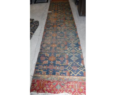 A large Ushak carpet section with foliate decoration in red and green, approx 404 cm x 97 cm