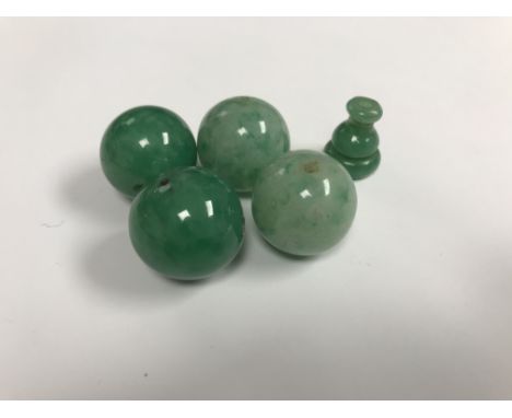 An oval Scandinavian wooden box containing two pairs of large jade beads and a turned bead CONDITION REPORTS The four beads a