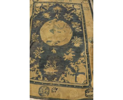 A Chinese carpet, the central panel set with animal and floral motifs on a blue ground, within a  stepped blue, mustard and f